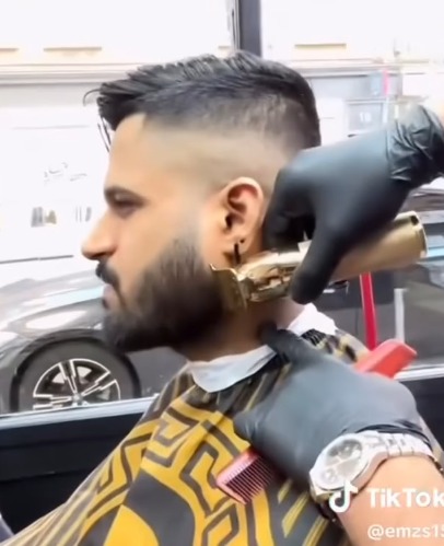 Precision beard trim with gold clippers